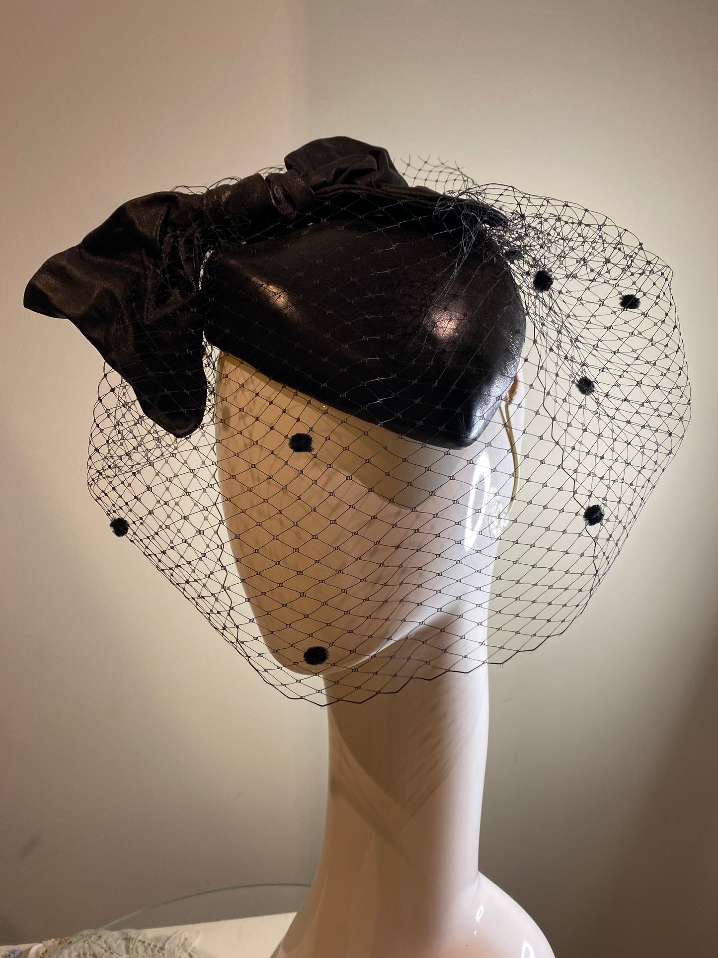 Black leather percher with stiffened bow