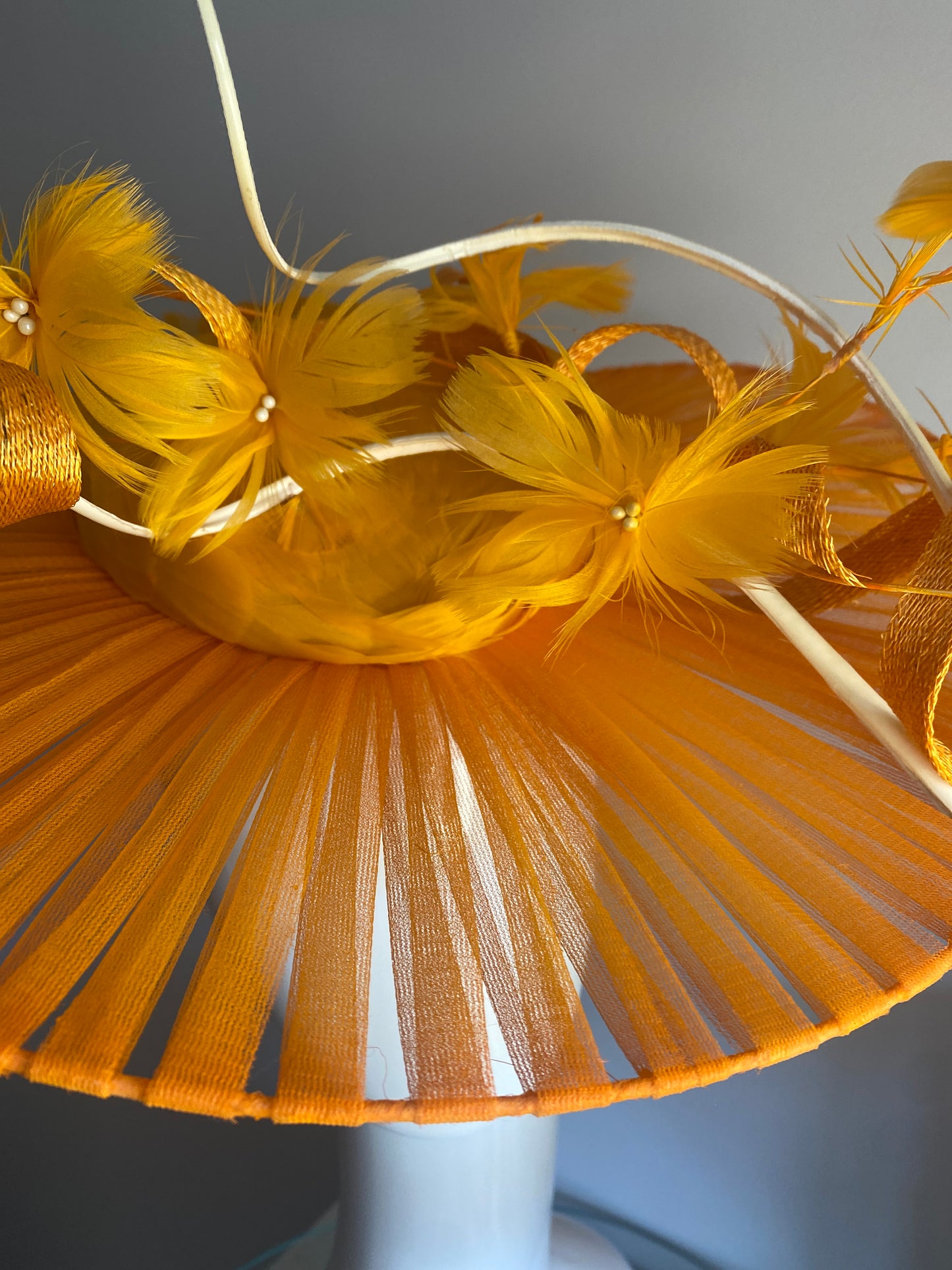 Orange feathered hat with transparent brim