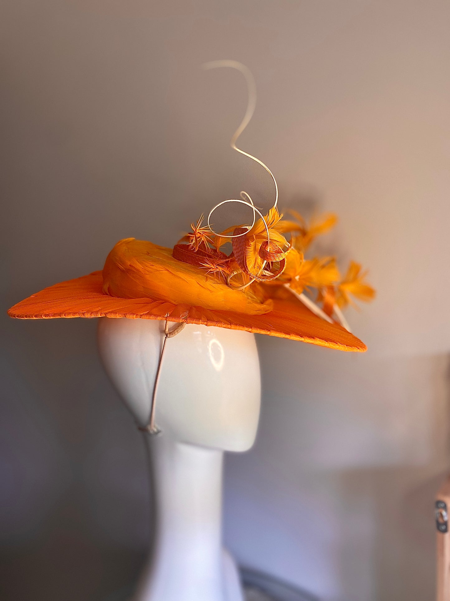 Orange feathered hat with transparent brim