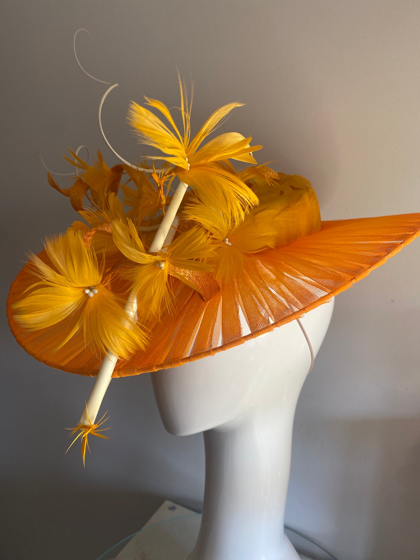 Orange feathered hat with transparent brim