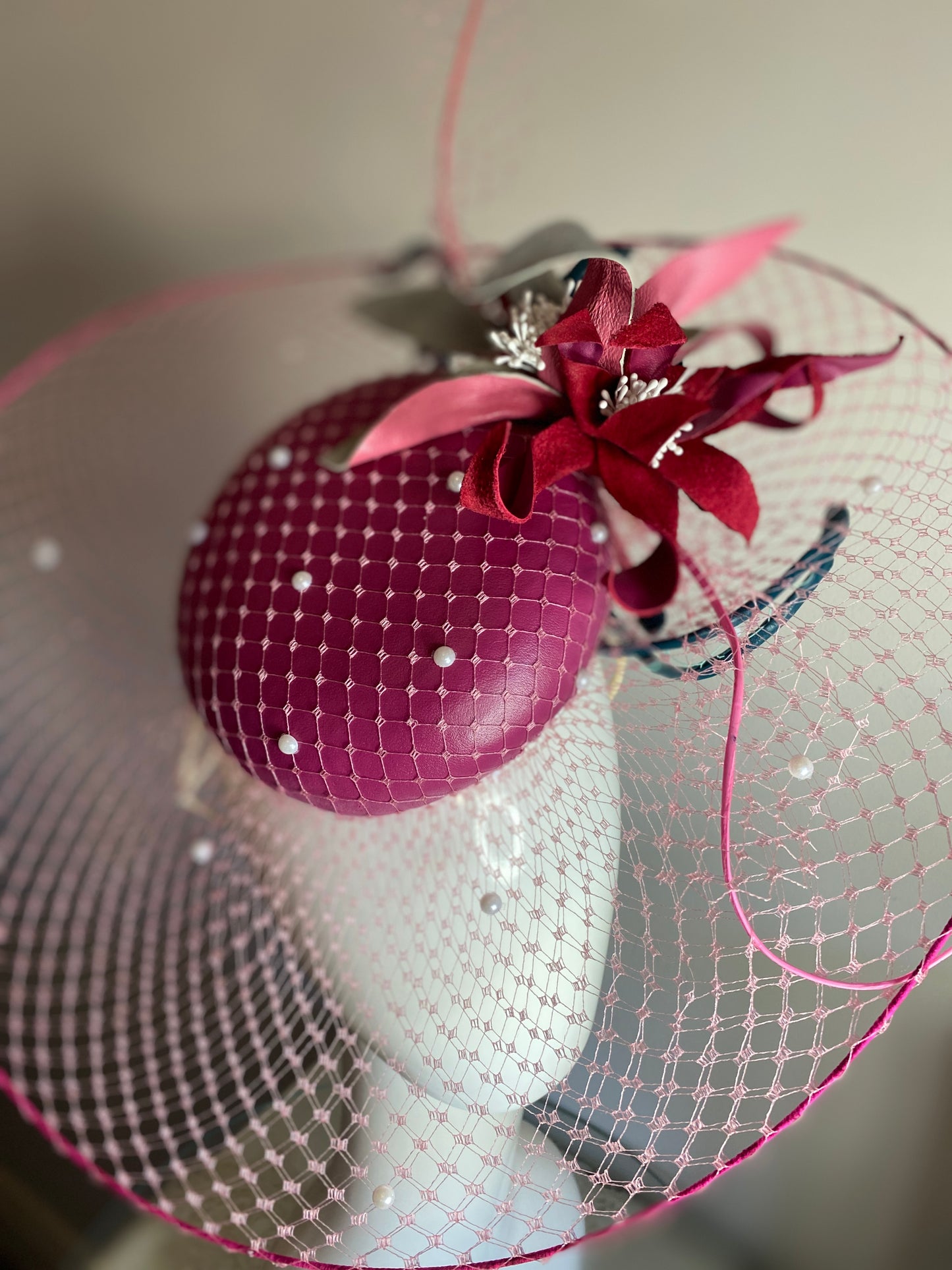 Magenta veiled brim button with leather flowers