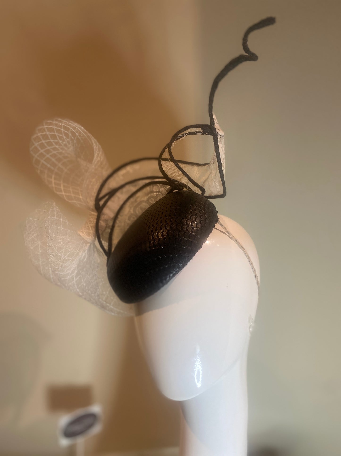 Black pleather button fascinator with swirls in white lace and crinoline