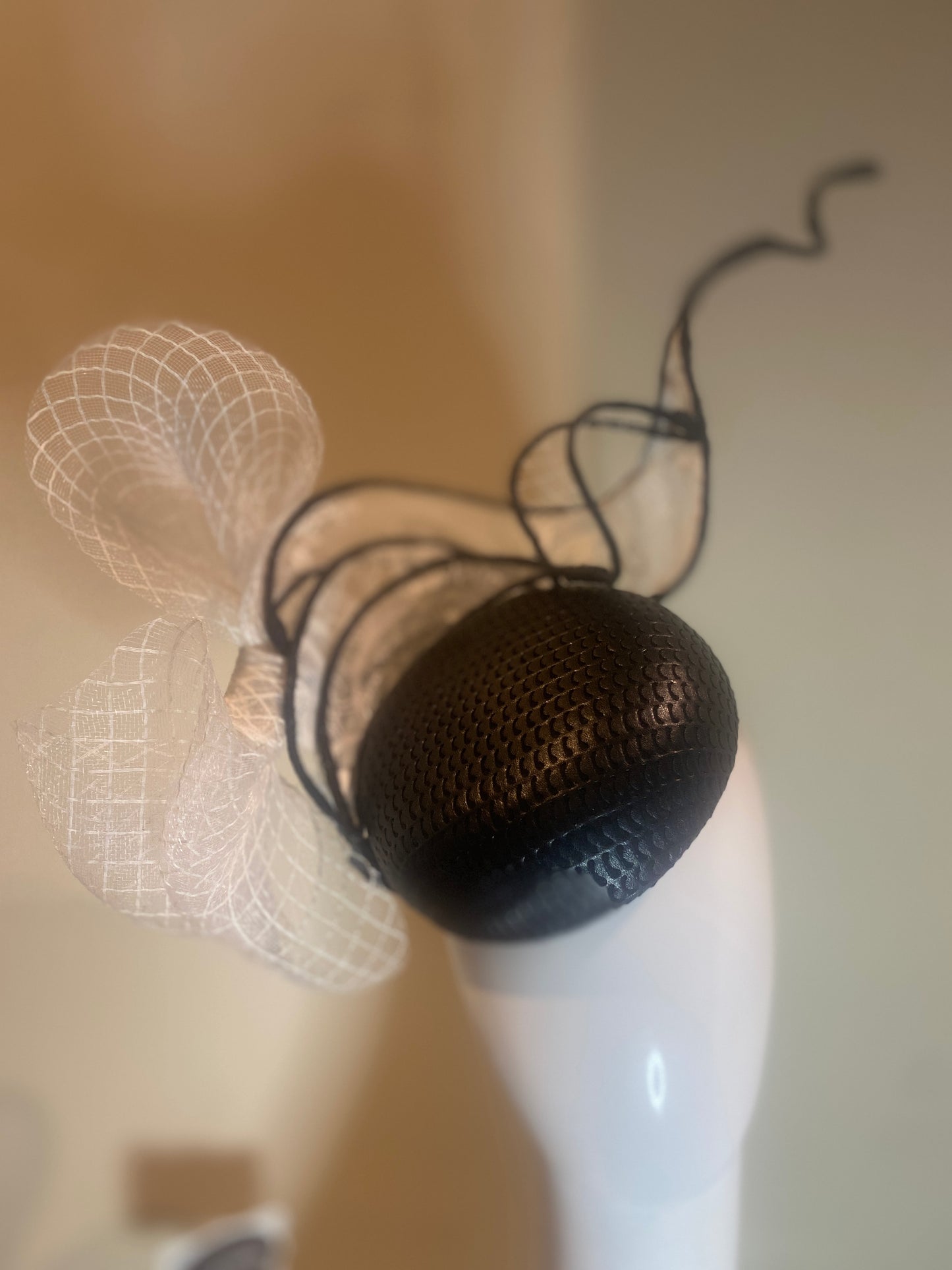 Black pleather button fascinator with swirls in white lace and crinoline