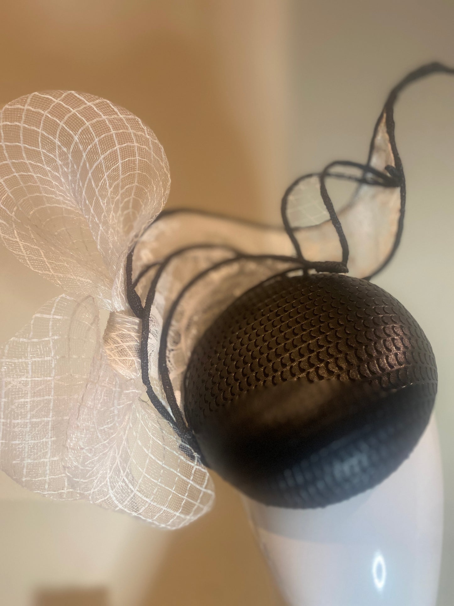 Black pleather button fascinator with swirls in white lace and crinoline