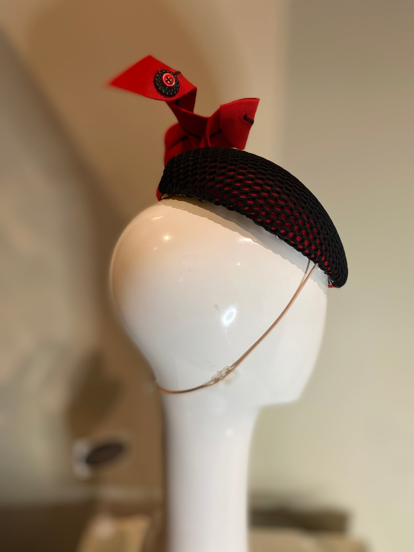 Red beret style percher with black mesh