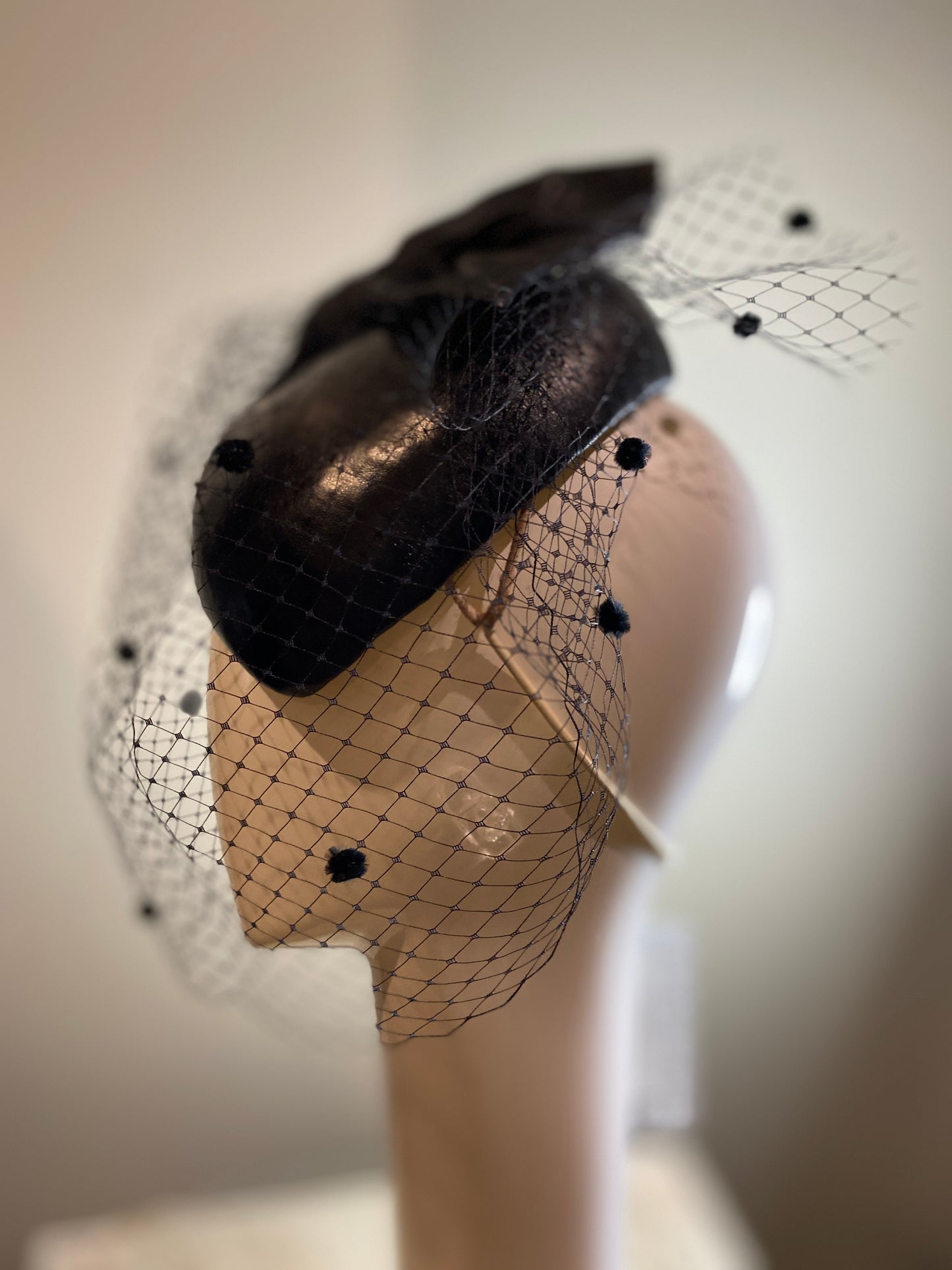 Black leather percher with stiffened bow